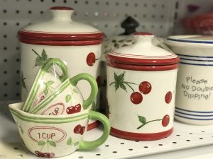 A set of jars and cups with a cherry design for sale at Sauk Centre STEP