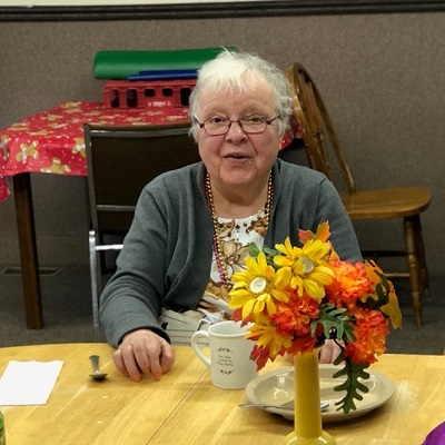 An older woman enjoys a cup of coffee at STEP's Activity and Senior Center in Browerville, MN.